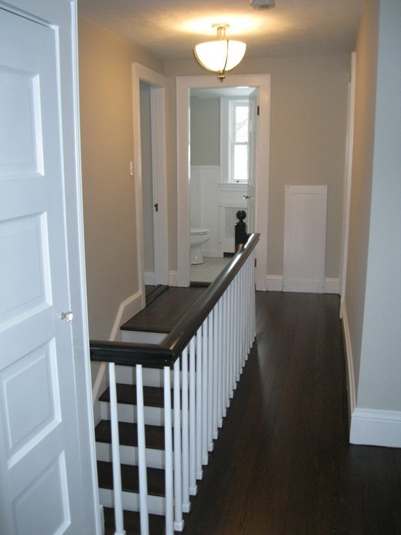 83 Flagg Street Worcester, MA 01602 - Photo 15 of 25 a view of a hallway to a livingroom with wooden floor and staircase