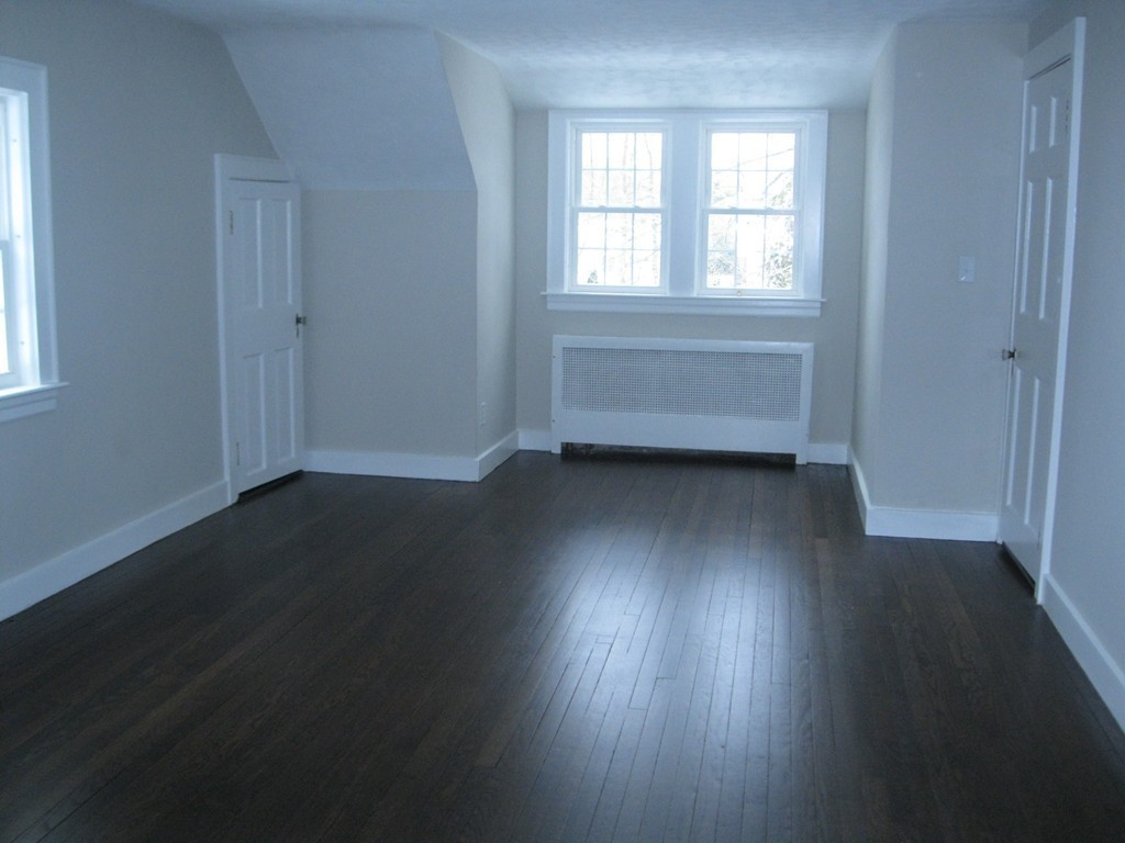 83 Flagg Street Worcester, MA 01602 - Photo 17 of 25 an empty room with wooden floor and windows