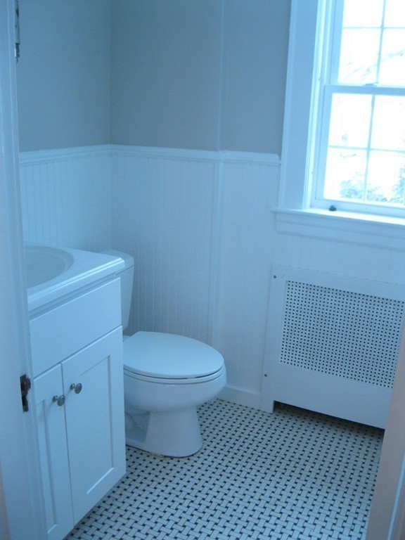 83 Flagg Street Worcester, MA 01602 - Photo 18 of 25 a bathroom with a toilet a sink and a window