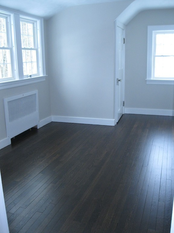 83 Flagg Street Worcester, MA 01602 - Photo 19 of 25 an empty room with wooden floor and windows