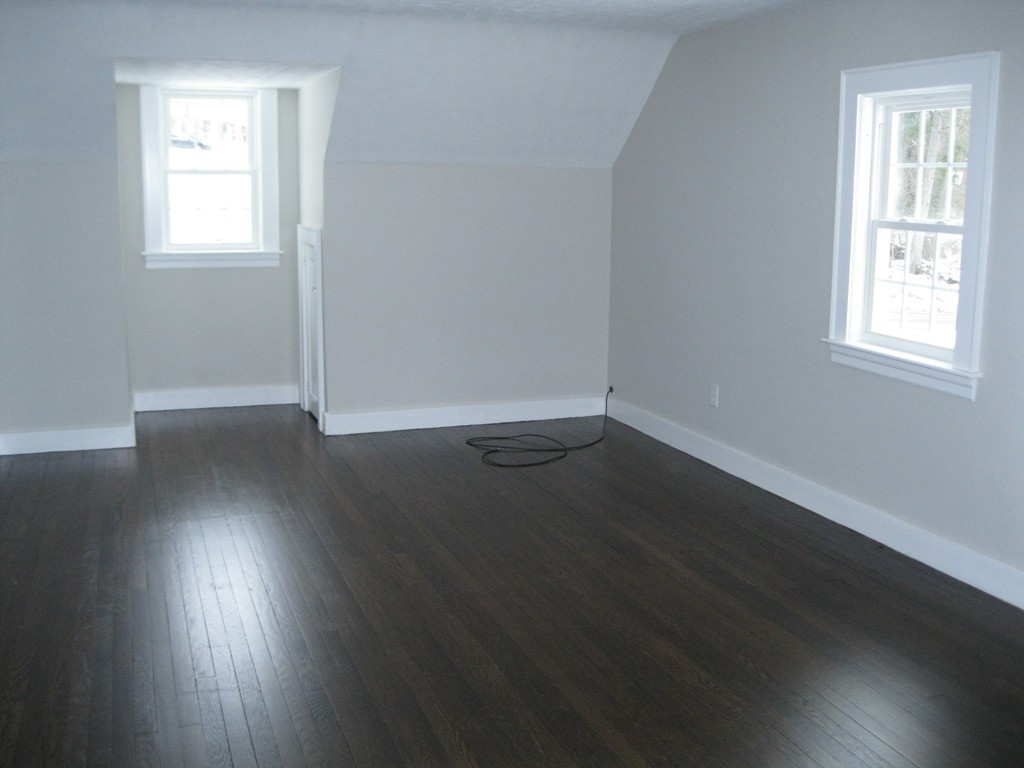 83 Flagg Street Worcester, MA 01602 - Photo 20 of 25 an empty room with wooden floor and windows