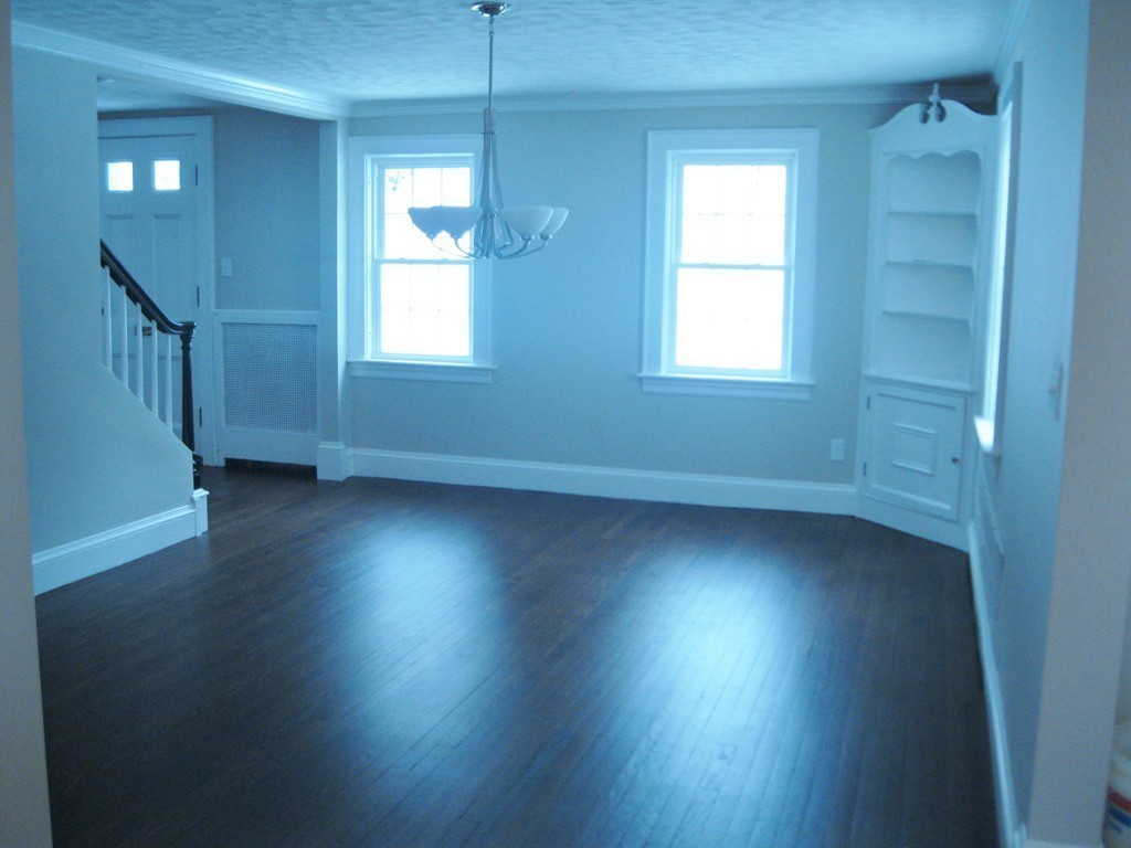 83 Flagg Street Worcester, MA 01602 - Photo 2 of 25 an empty room with wooden floor and windows