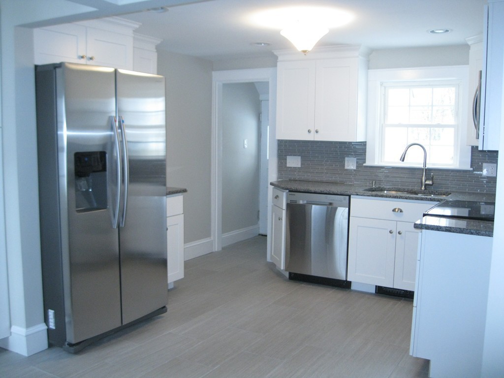 83 Flagg Street Worcester, MA 01602 - Photo 4 of 25 a kitchen with stainless steel appliances granite countertop a refrigerator and a sink