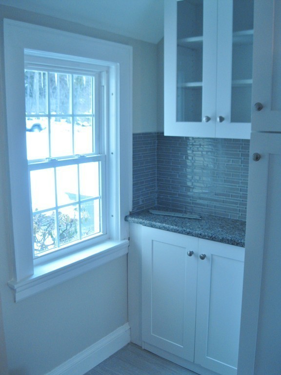 83 Flagg Street Worcester, MA 01602 - Photo 5 of 25 a kitchen with granite countertop white cabinets and a window
