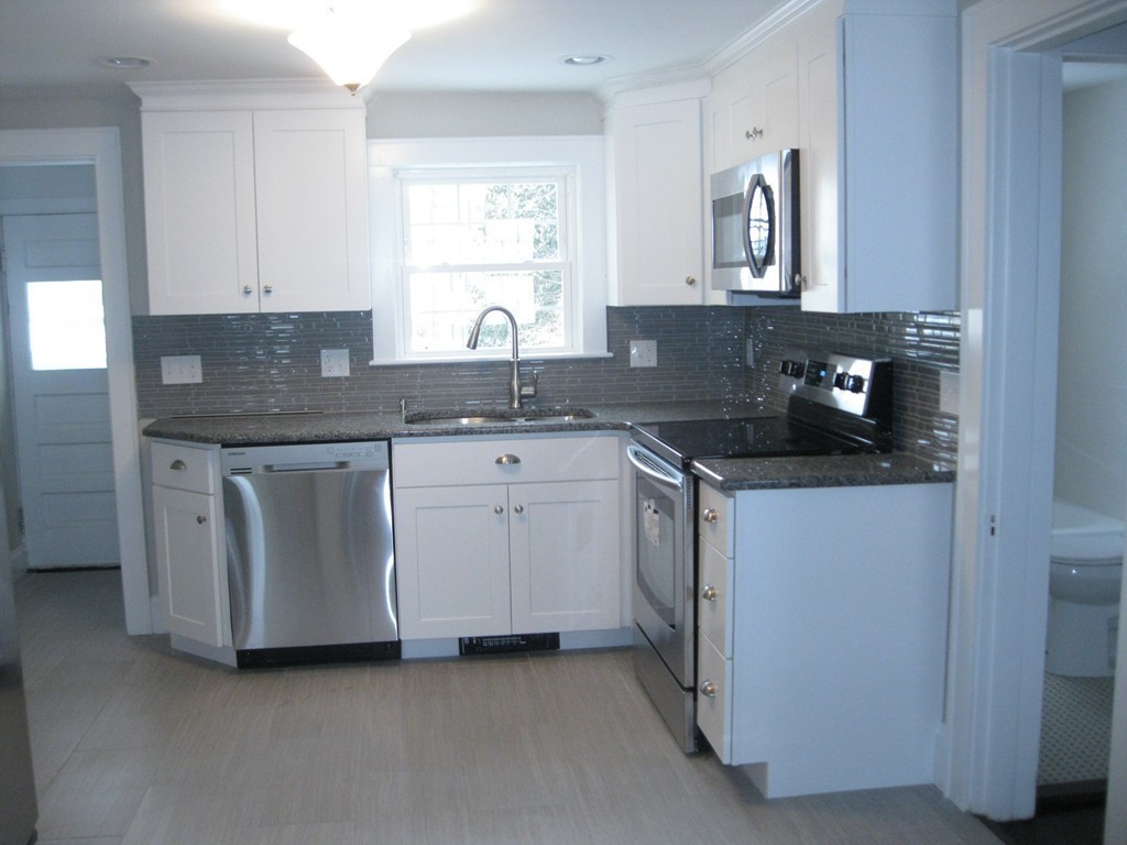 83 Flagg Street Worcester, MA 01602 - Photo 6 of 25 a kitchen with a sink and cabinets