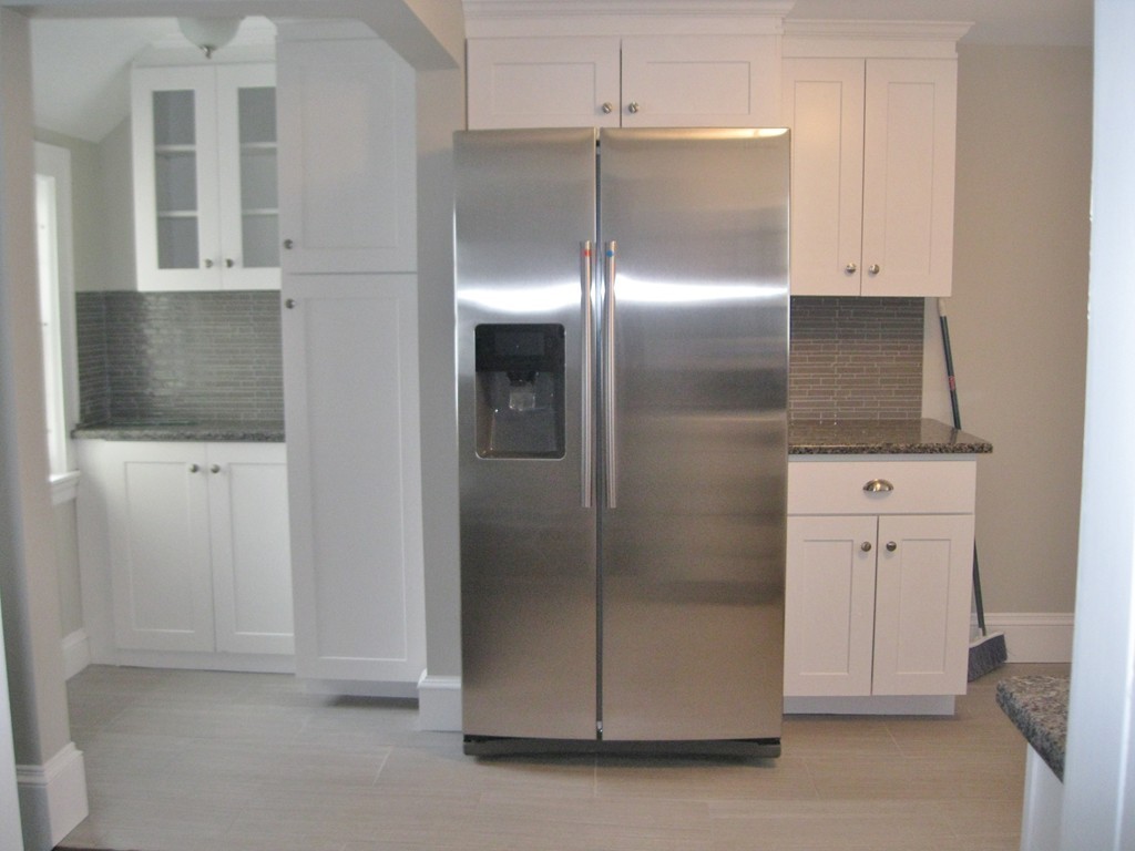 83 Flagg Street Worcester, MA 01602 - Photo 7 of 25 a view of a refrigerator in kitchen and white cabinets