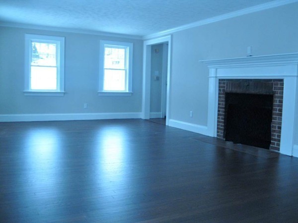 83 Flagg Street Worcester, MA 01602 - Photo 8 of 25 an empty room with wooden floor and windows