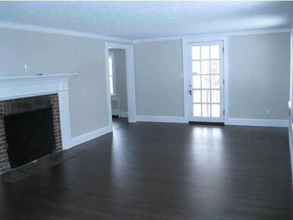 83 Flagg Street Worcester, MA 01602 - Photo 9 of 25 an empty room with wooden floor and fireplace