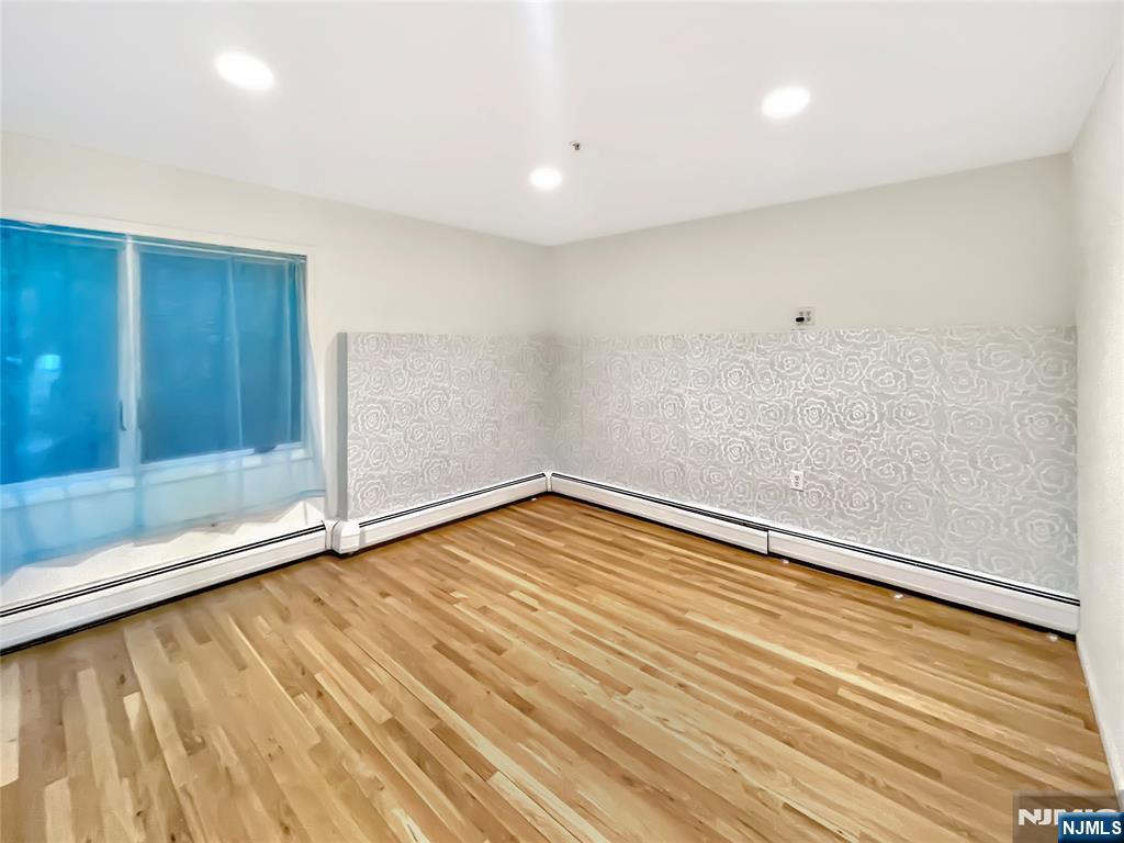 8913 Riverside Place, Unit 3 North Bergen, NJ 07047 - Photo 9 of 17 a view of empty room with wooden floor