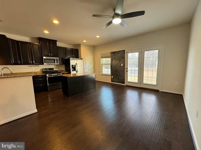 a view of kitchen with microwave and wooden floor