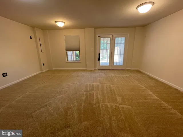 a view of an empty room with windows