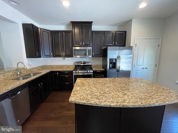 a kitchen with granite countertop wooden cabinets and a granite counter tops