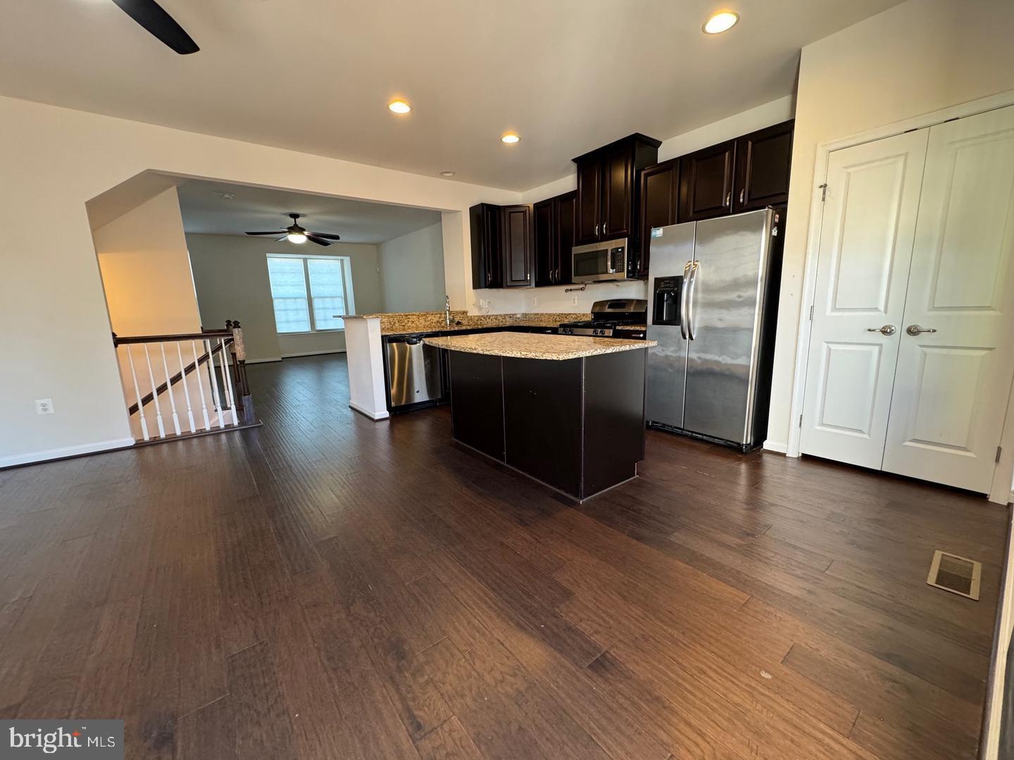 11506 Accord Court Fredericksburg, VA 22408 - Photo 9 of 20 a large kitchen with stainless steel appliances wooden floors and view living room