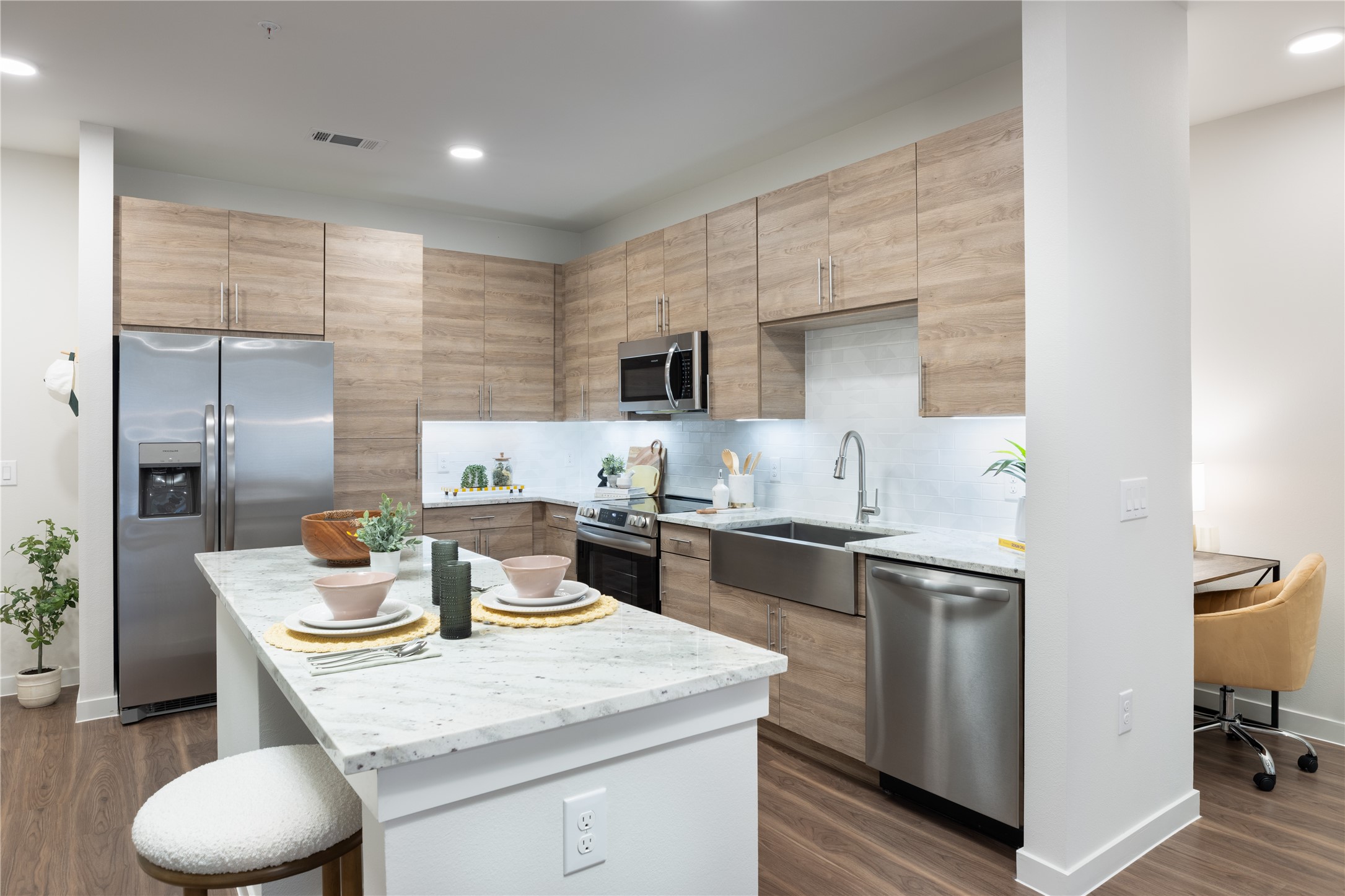 a kitchen with a sink a stove and chairs
