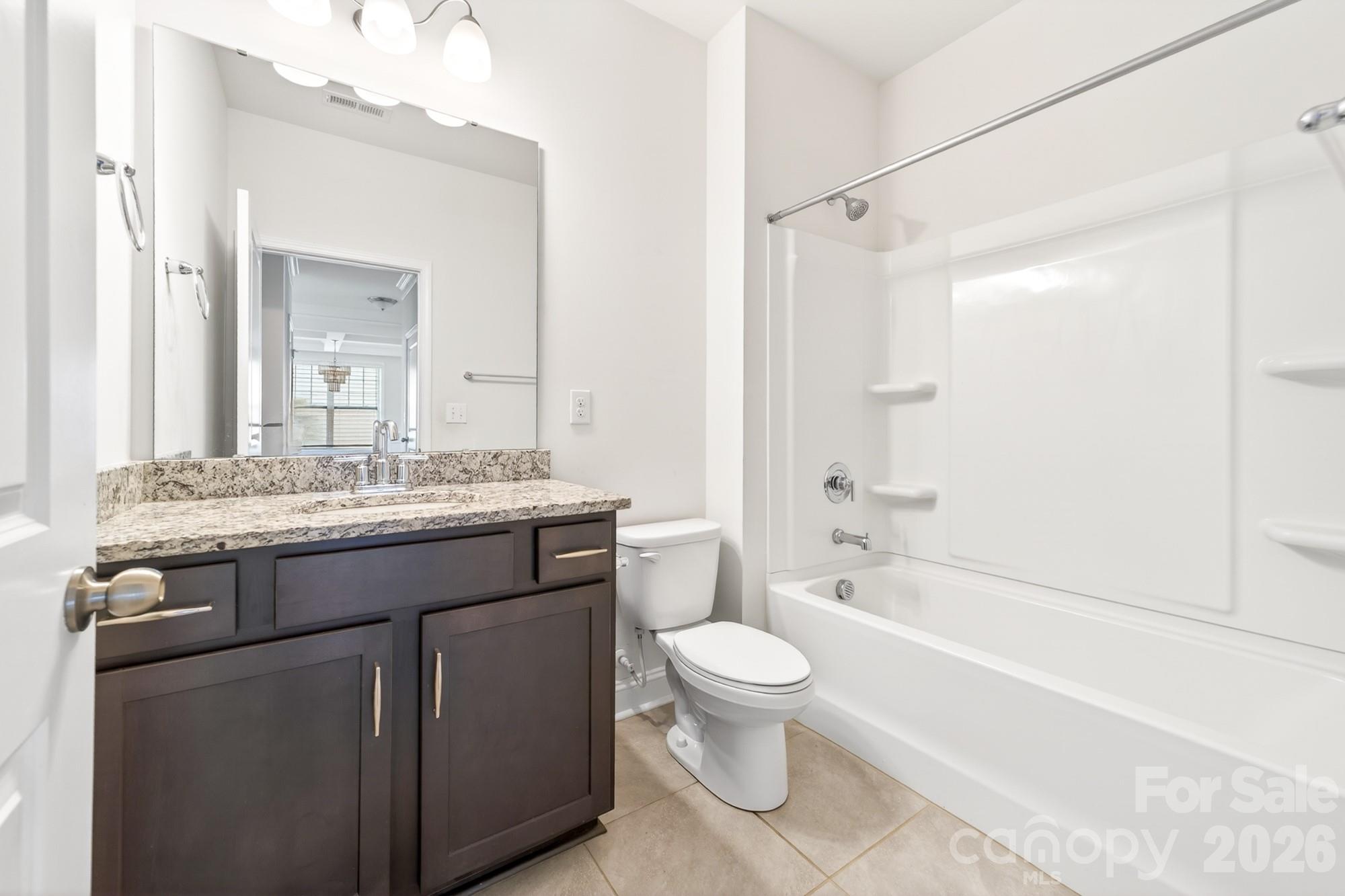 5972 Redwood Pine Road Concord, NC 28027 - Photo 18 of 37 a bathroom with a granite countertop sink a toilet and shower