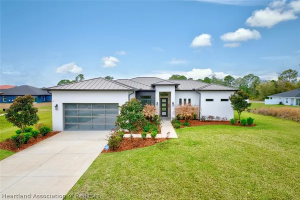 a front view of a house with a garden and yard