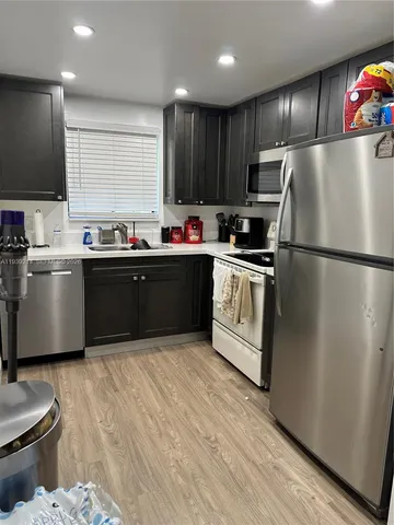 a kitchen with wooden cabinets and stainless steel appliances