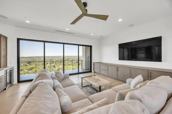 a large dining hall with stainless steel appliances granite countertop a stove and a sink
