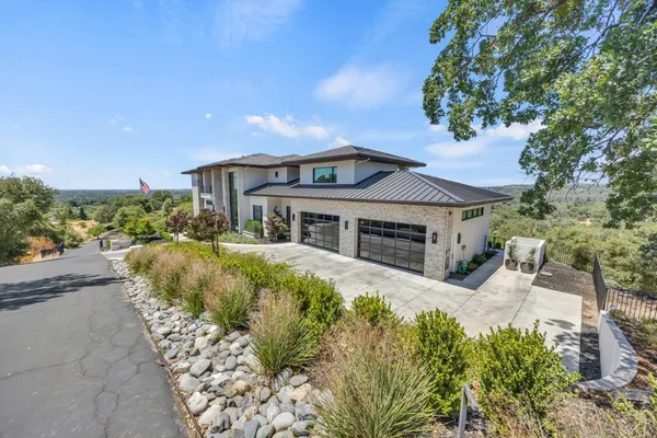 a kitchen with stainless steel appliances kitchen island granite countertop a table chairs sink and cabinets