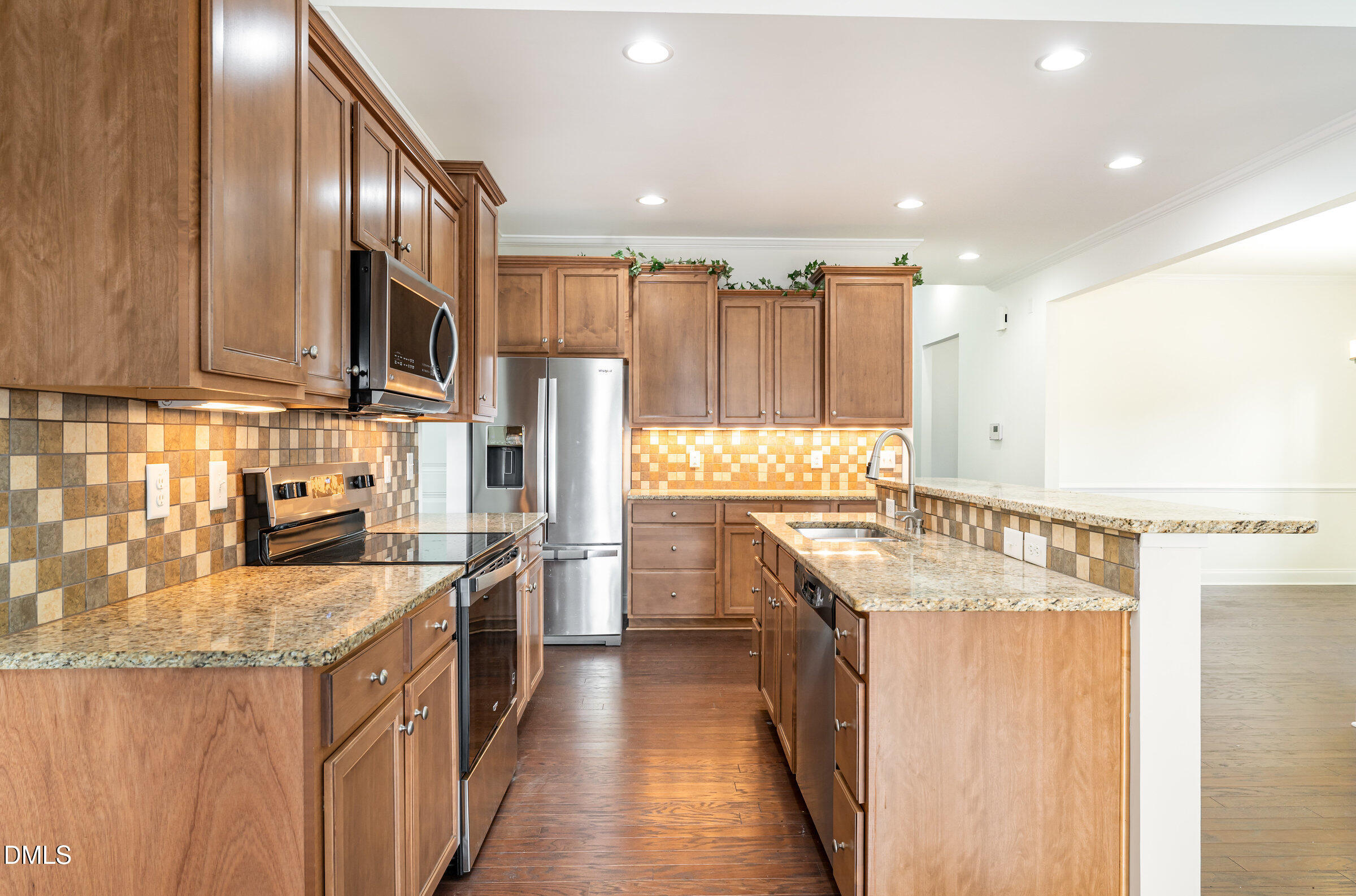 105 Leesville Loop Aberdeen, NC 28315 - Photo 10 of 32 a kitchen with stainless steel appliances granite countertop a sink a stove and a refrigerator