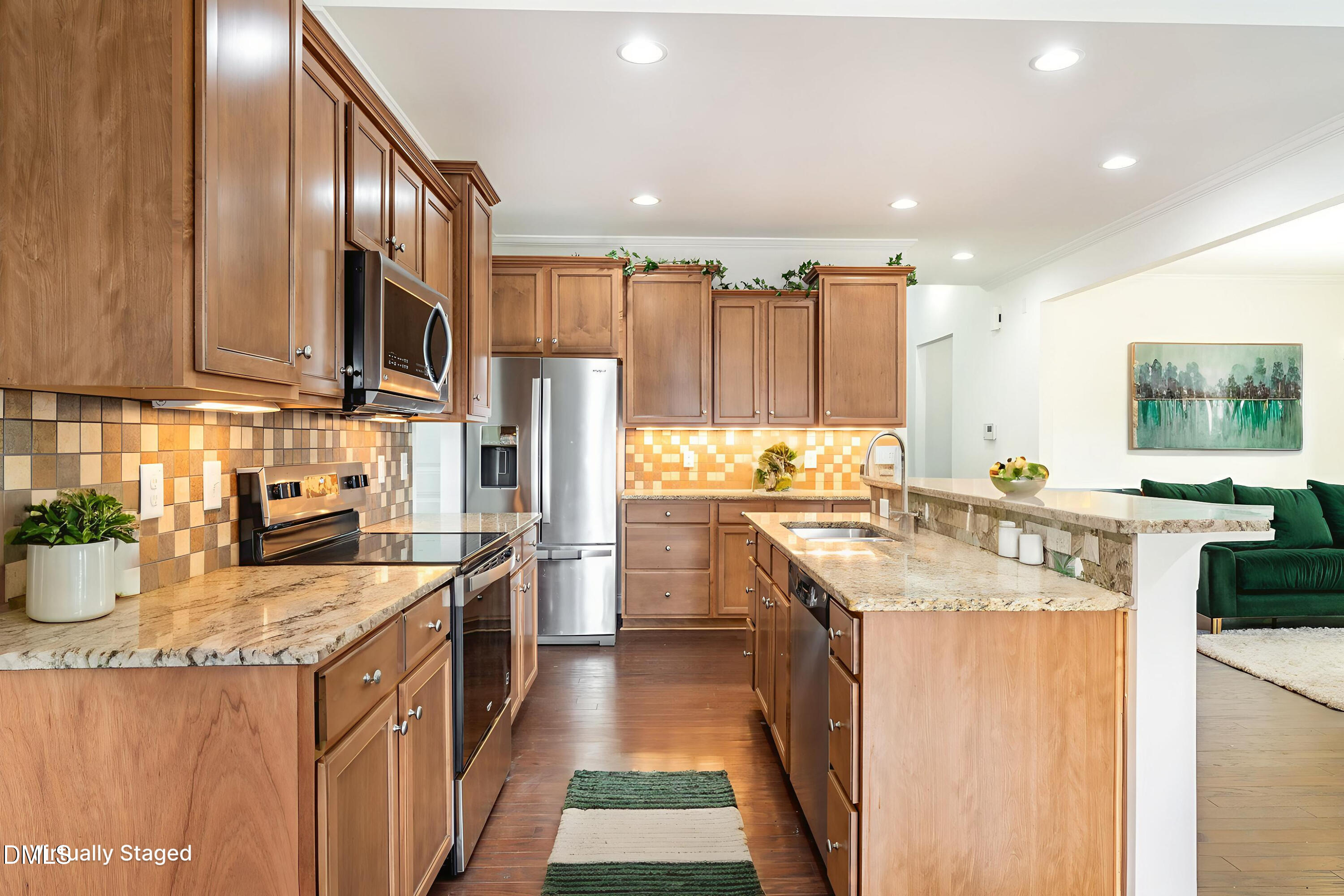 105 Leesville Loop Aberdeen, NC 28315 - Photo 11 of 32 a kitchen with stainless steel appliances granite countertop a sink a stove and a refrigerator