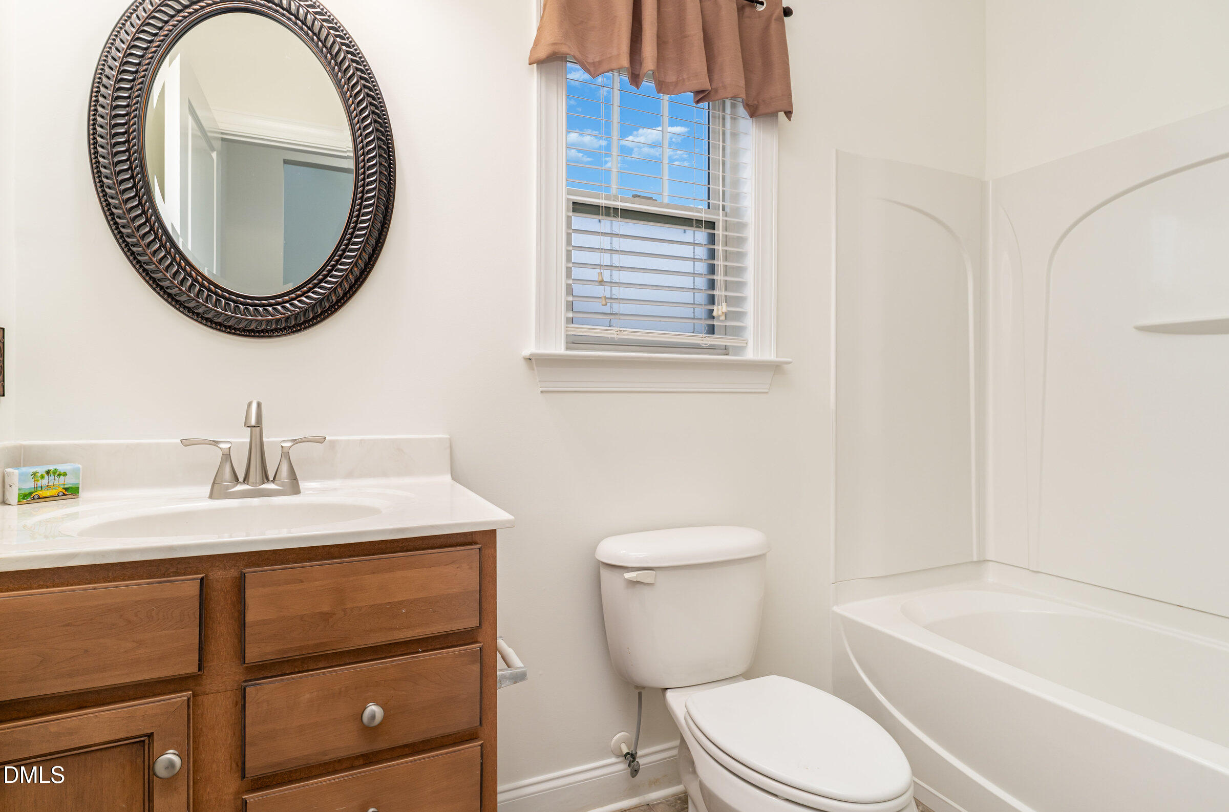 105 Leesville Loop Aberdeen, NC 28315 - Photo 22 of 32 a bathroom with a toilet a sink and a mirror