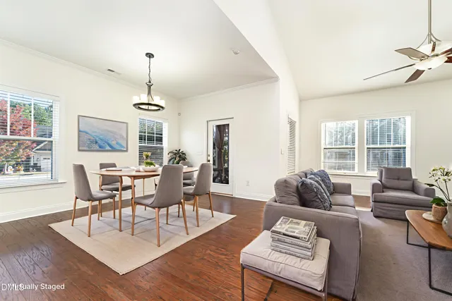 a living room with furniture dining table and a large window
