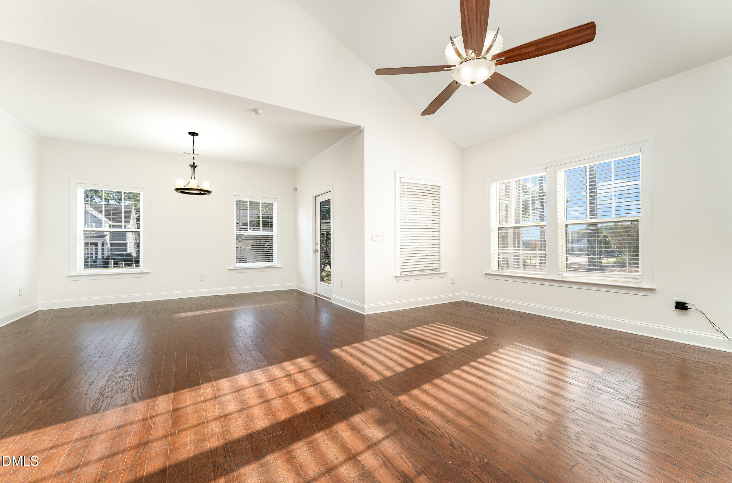 105 Leesville Loop Aberdeen, NC 28315 - Photo 8 of 32 a view of a livingroom with wooden floor and a ceiling fan