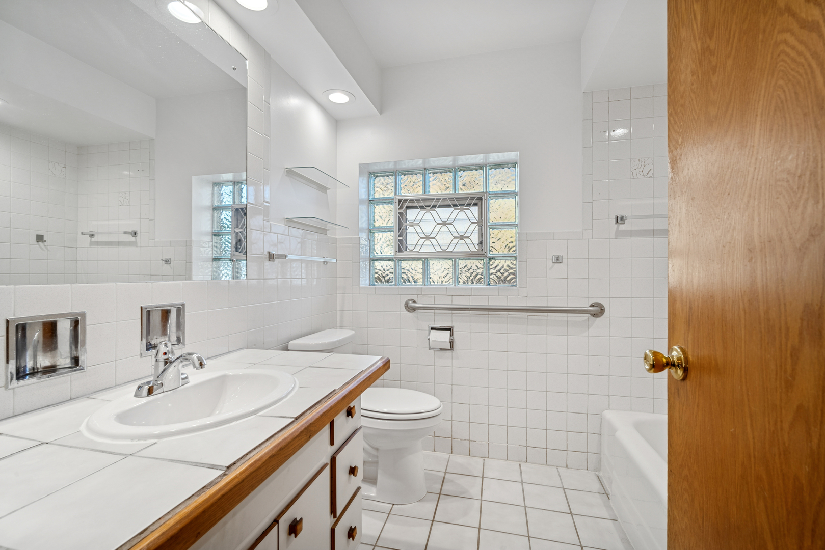 6800 North Overhill Avenue, Unit 1A Chicago, IL 60631 - Photo 12 of 20 a bathroom with a sink toilet a mirror and shower
