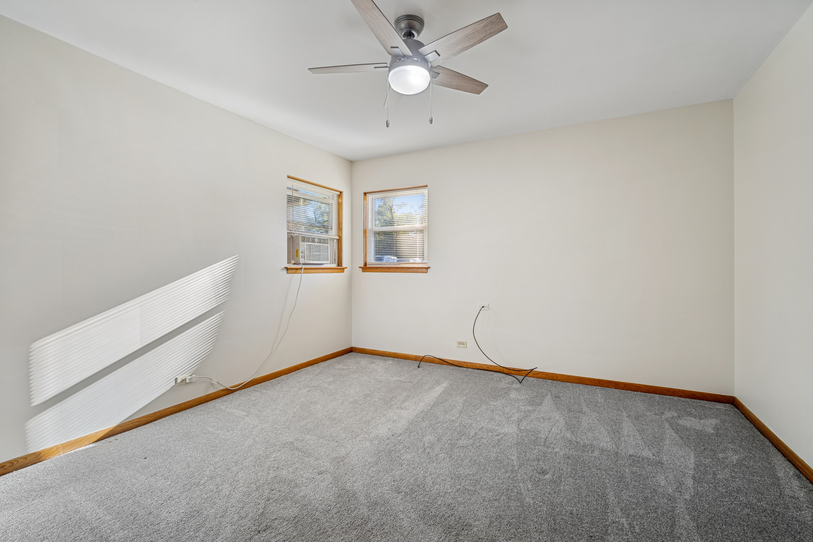 6800 North Overhill Avenue, Unit 1A Chicago, IL 60631 - Photo 14 of 20 an empty room with windows and ceiling fan