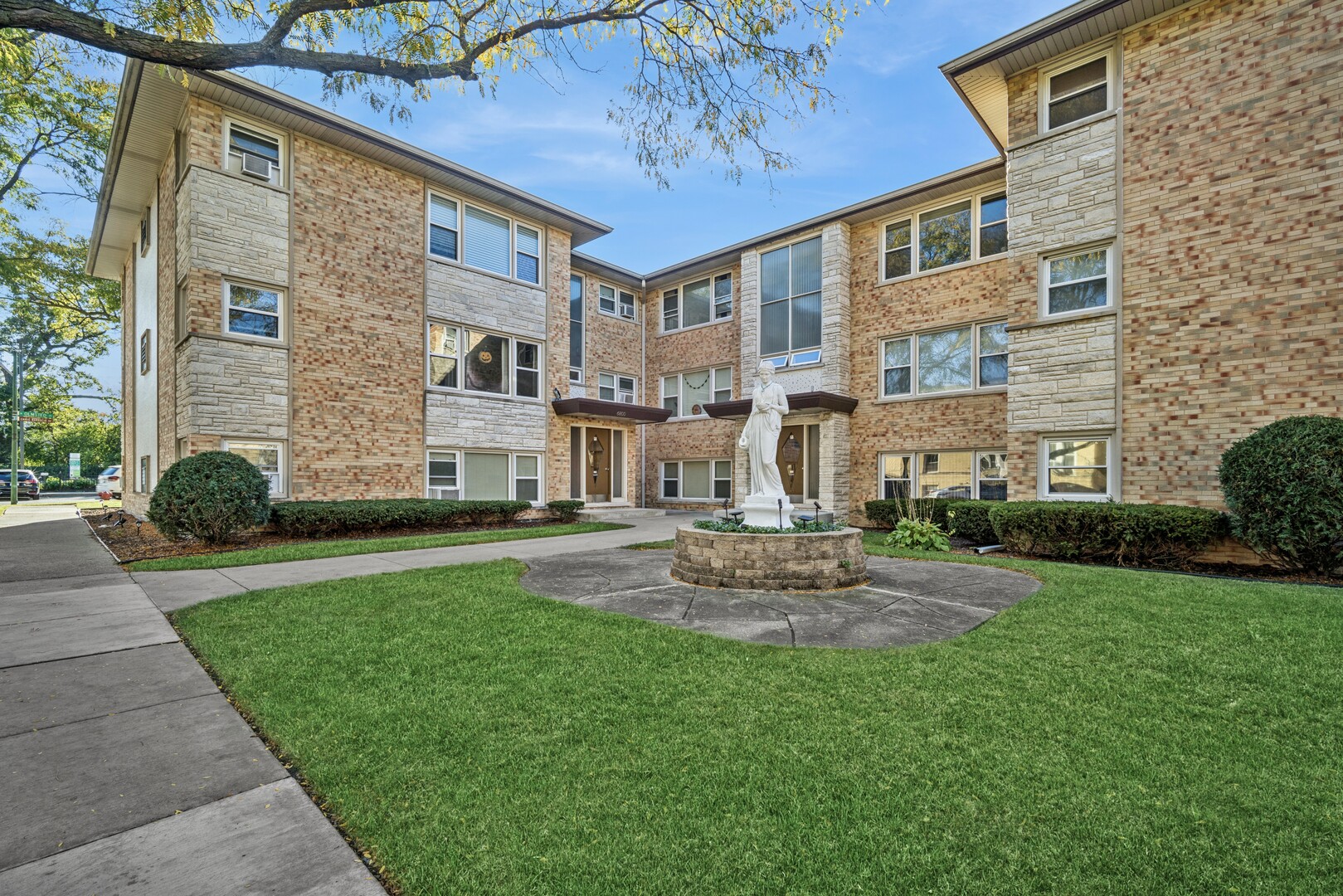 6800 North Overhill Avenue, Unit 1A Chicago, IL 60631 - Photo 18 of 20 a view of a house with a yard and sitting area