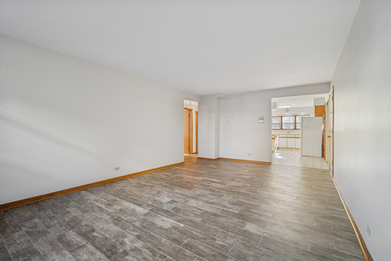 6800 North Overhill Avenue, Unit 1A Chicago, IL 60631 - Photo 4 of 20 a view of empty room with wooden floor