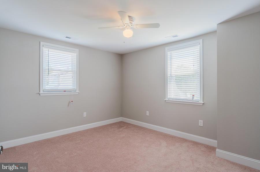 32 Midship Road Dundalk, MD 21222 - Photo 14 of 30 an empty room with a window and a fan