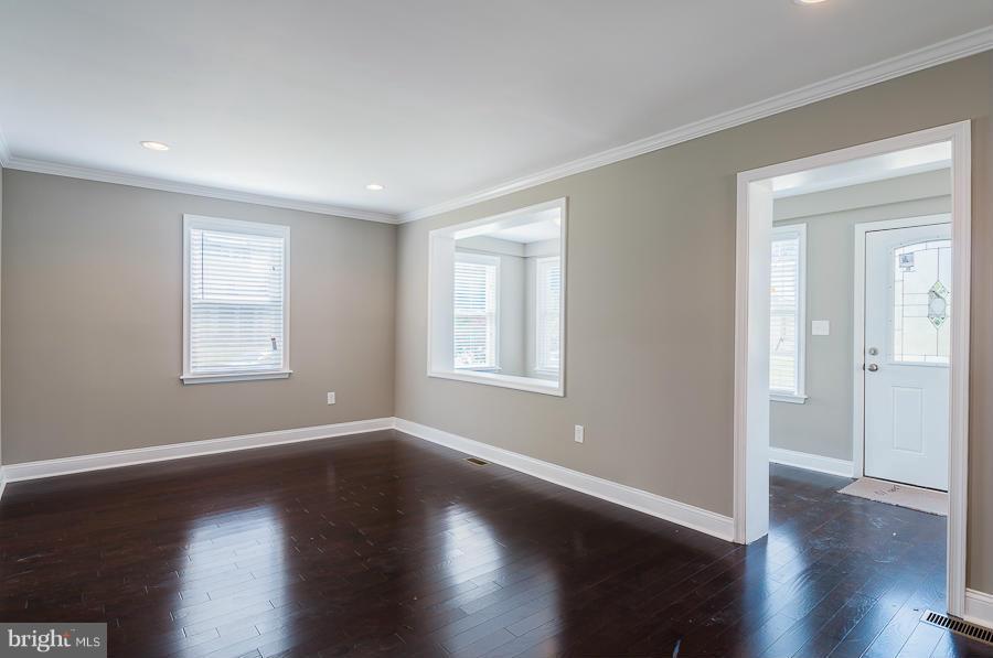 32 Midship Road Dundalk, MD 21222 - Photo 3 of 30 a view of an empty room with wooden floor and a window