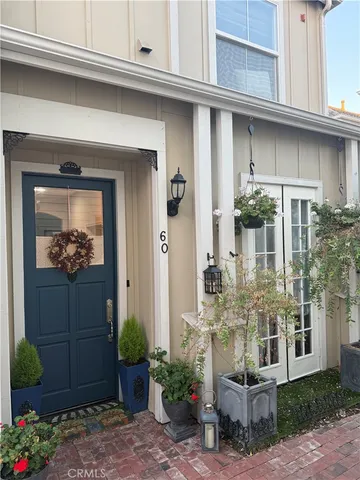 a front view of a house with plants