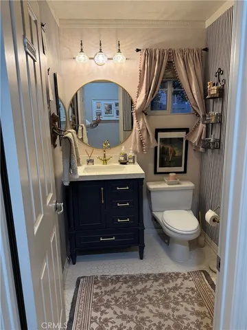 a bathroom with a toilet a sink and mirror