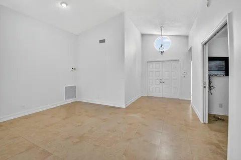 an empty room with windows and entrance