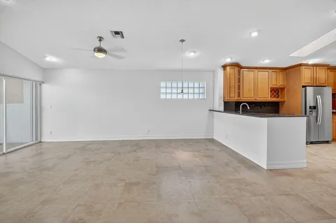 a kitchen with stainless steel appliances granite countertop a refrigerator and microwave