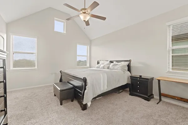 a bedroom with a bed and a window