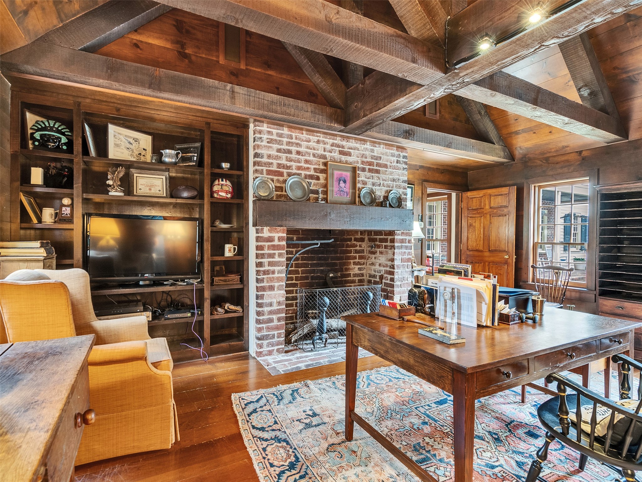5212 Strack Road Houston, TX 77069 - Photo 16 of 42 Authenticity meets comfort here, featuring another warm fireplace and panoramic views of the grounds, creating the perfect spot for morning coffee.