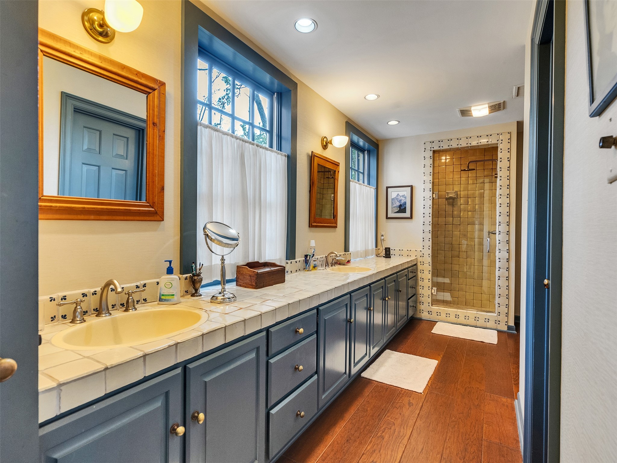 5212 Strack Road Houston, TX 77069 - Photo 24 of 42 Primary bathroom has dual vanities, his and her closets, separate standing shower, and a large tub.