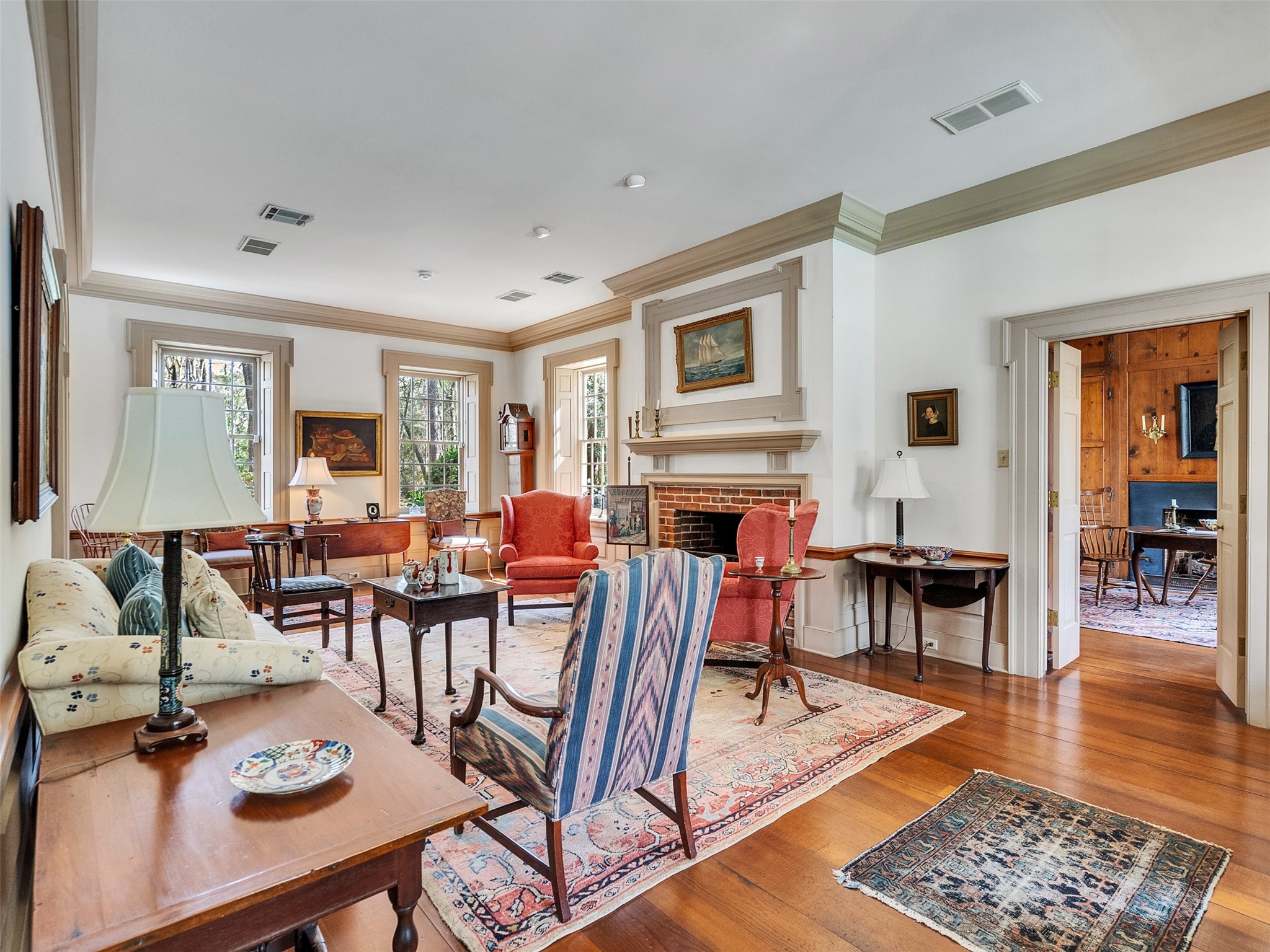 5212 Strack Road Houston, TX 77069 - Photo 5 of 42 Alternate view which is centered around a distinguished fireplace featuring handmade Alwine brick. Framed by a classic mantle and refined dental molding, this centerpiece provides a warm focal point.