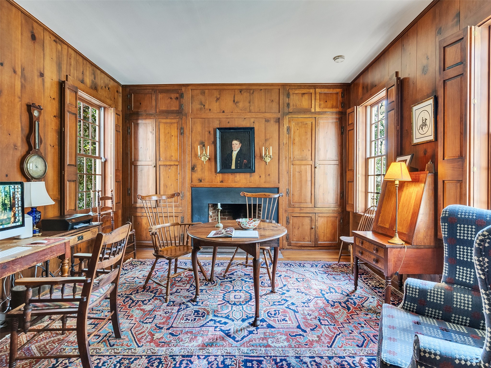 5212 Strack Road Houston, TX 77069 - Photo 7 of 42 Step back in time within this exquisite library, where floor-to-ceiling wood paneling and a dedicated fireplace create an atmosphere of scholarly retreat.