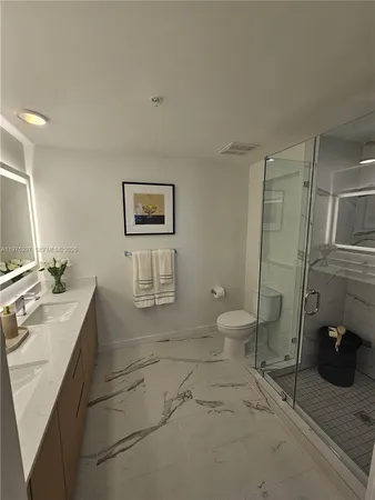 a bathroom with a toilet sink and shower