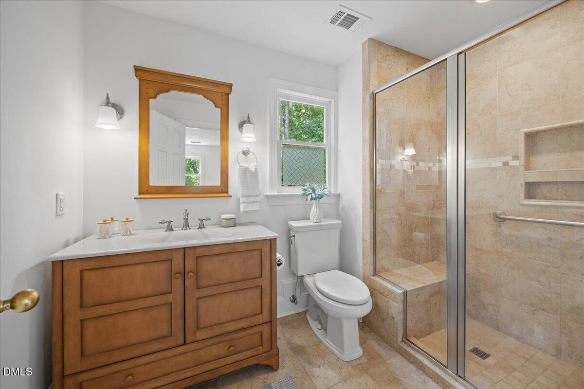 6516 Bakersfield Drive Raleigh, NC 27606 - Photo 34 of 59 a bathroom with a toilet shower vanity and a sink