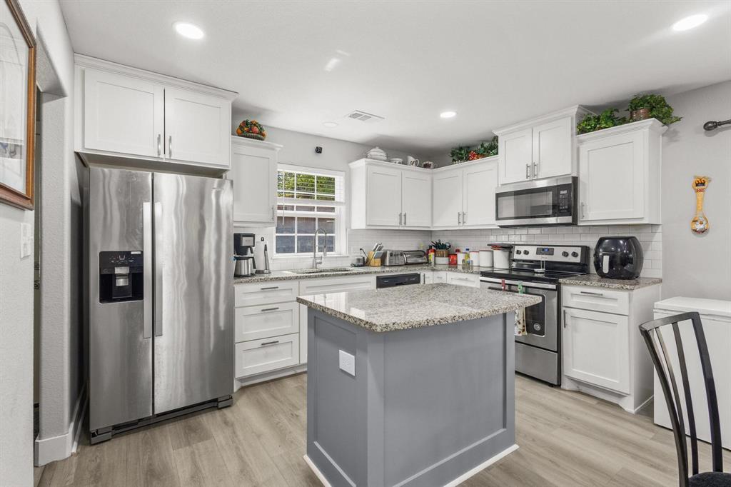 608 East Shepherd Street Denison, TX 75021 - Photo 12 of 31 a kitchen with stainless steel appliances granite countertop a refrigerator stove microwave and sink