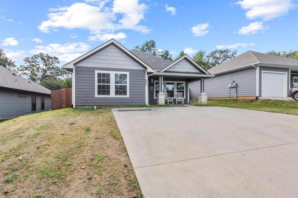 608 East Shepherd Street Denison, TX 75021 - Photo 2 of 31 a front view of a house with a yard and garage