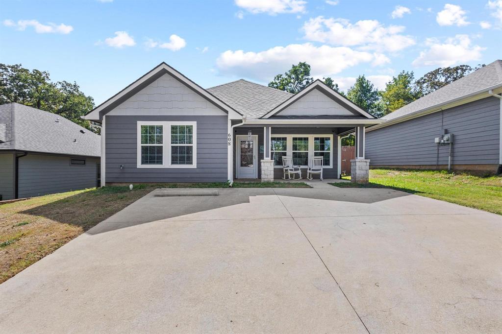 608 East Shepherd Street Denison, TX 75021 - Photo 3 of 31 a front view of a house with a yard and garage