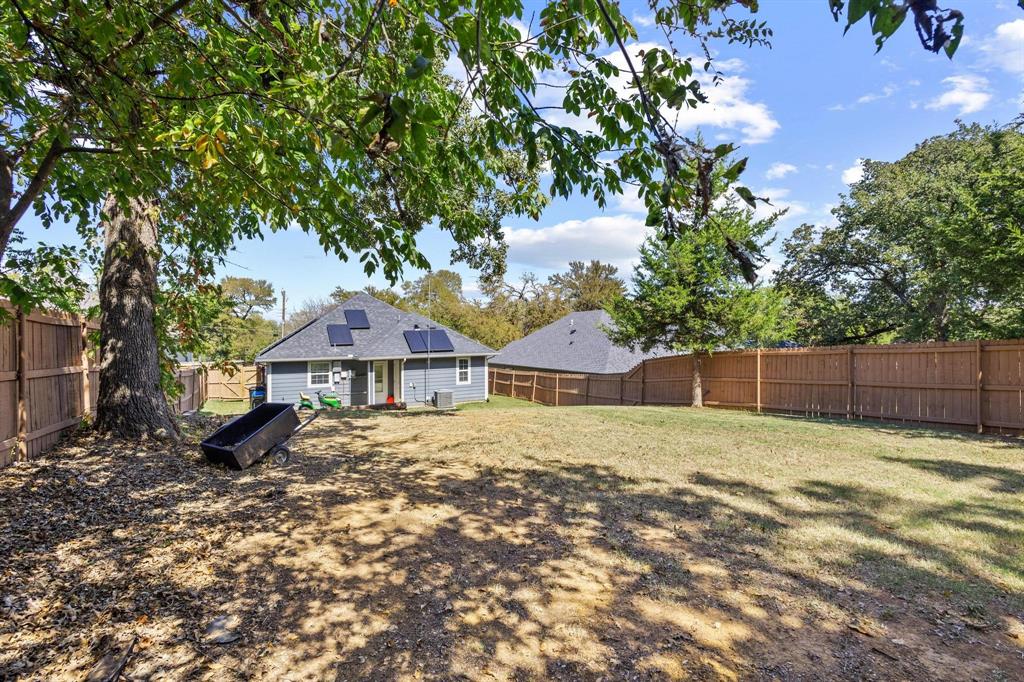 608 East Shepherd Street Denison, TX 75021 - Photo 30 of 31 a house with a tree in front of it