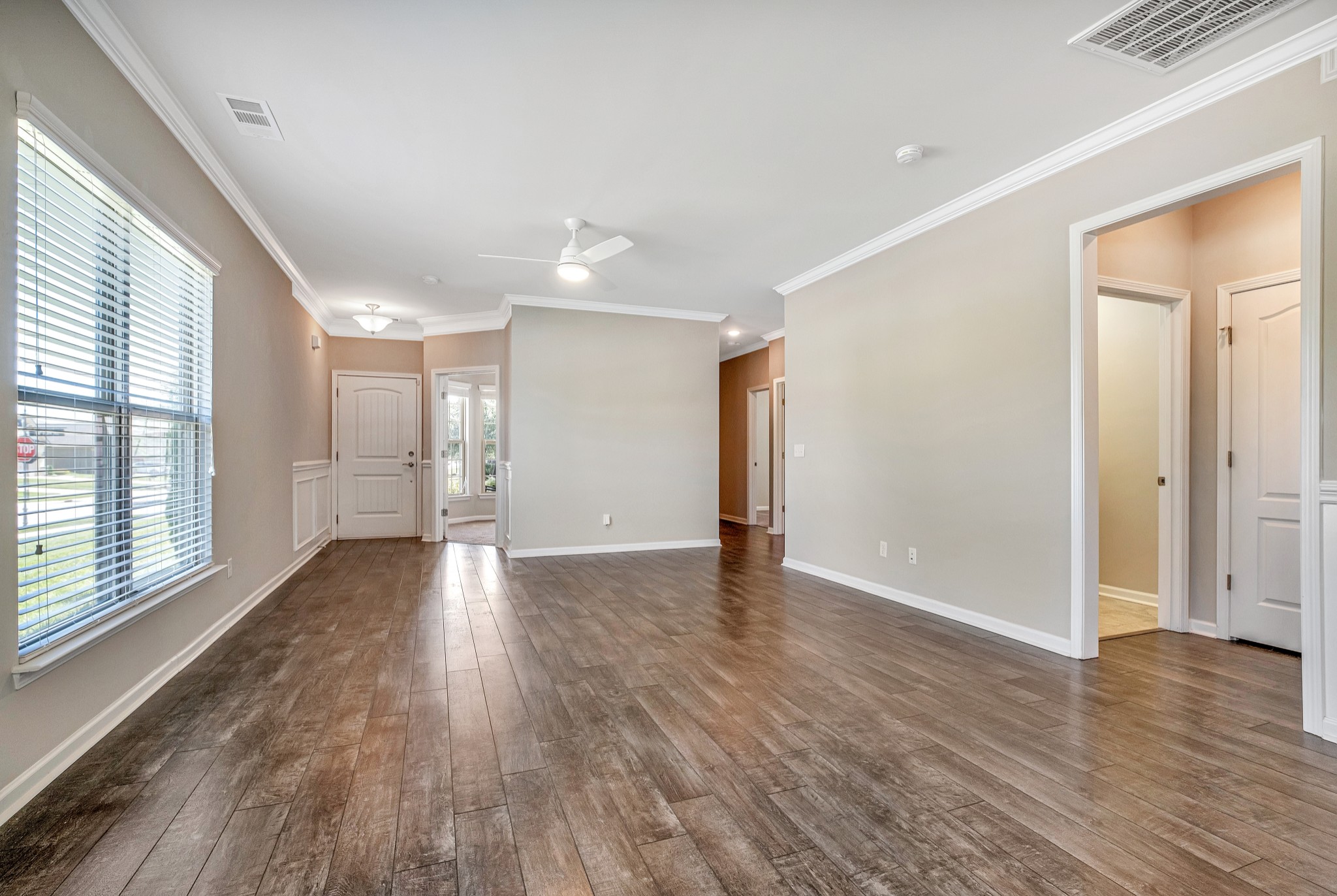 104 Tipton Pass Spring Hill, TN 37174 - Photo 12 of 57 a view of an empty room with wooden floor and a window